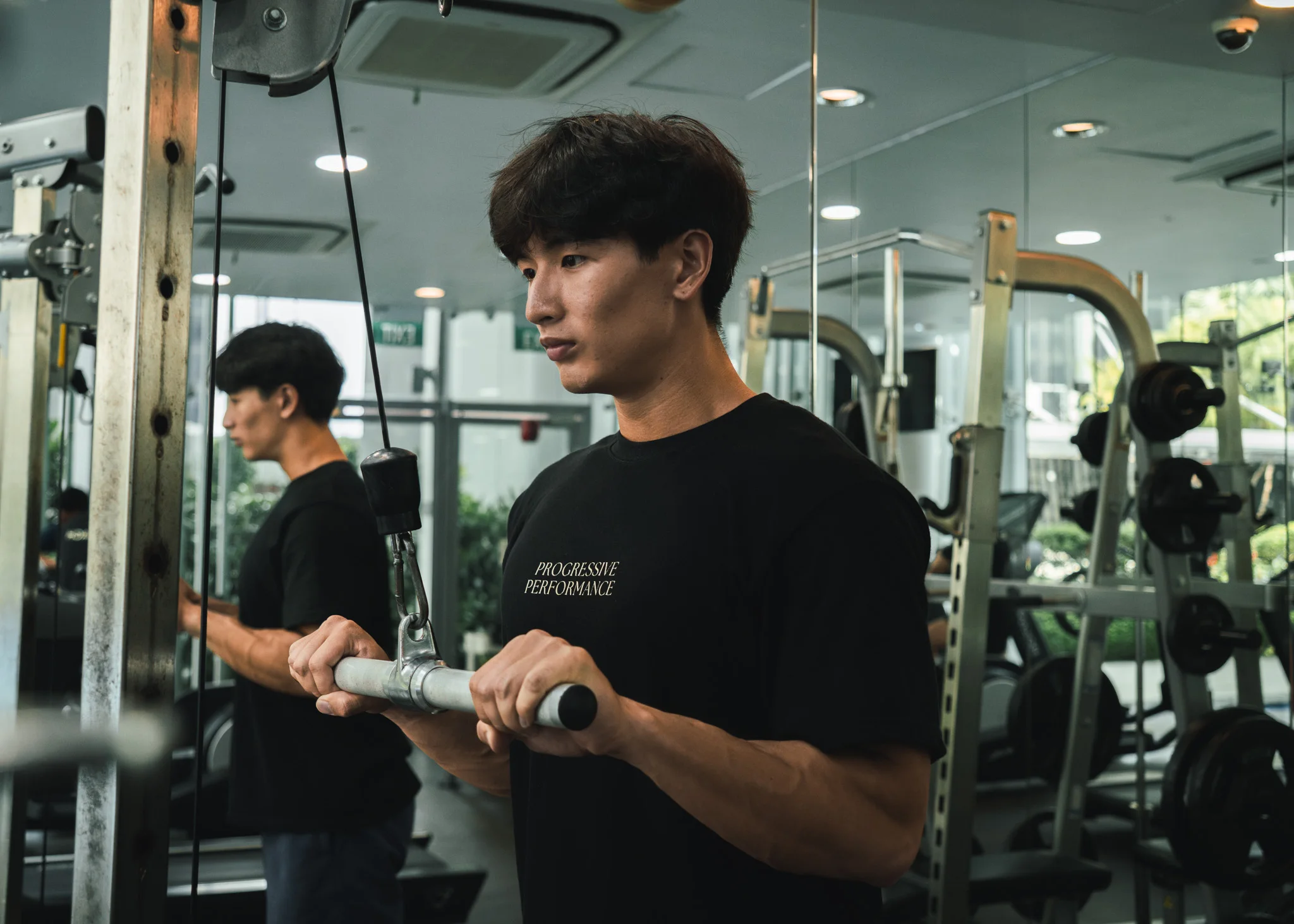 Progressive Performance team member demonstrating a cable exercise in the studio.