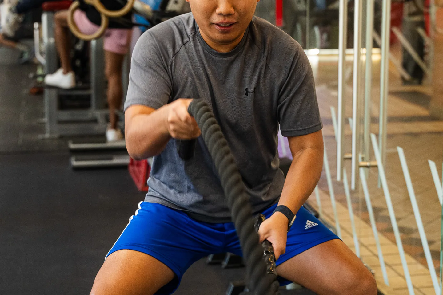 A client working through battle rope conditioning